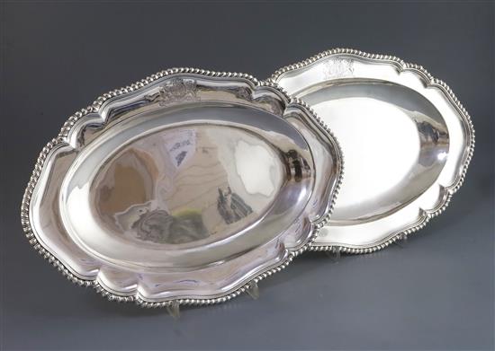 A near pair of George II/George III silver shaped oval meat dishes, 47 oz.